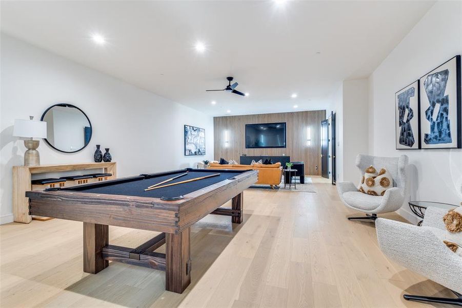 Playroom with ceiling fan, light hardwood / wood-style flooring, and pool table