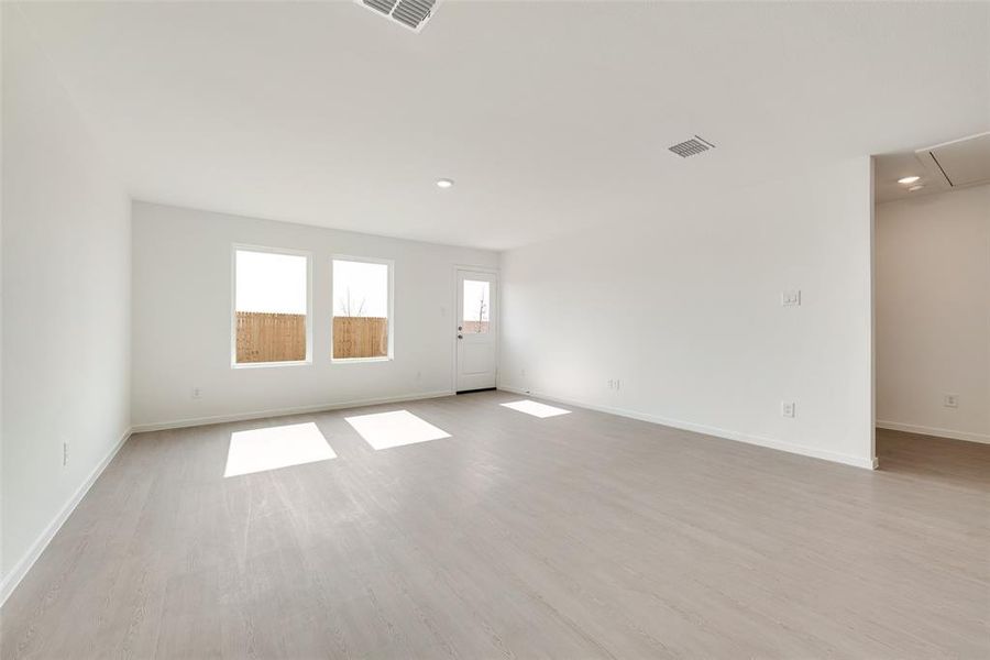 Unfurnished room with light wood finished floors and recessed lighting Unfurnished room with light wood finished floors and recessed lighting
