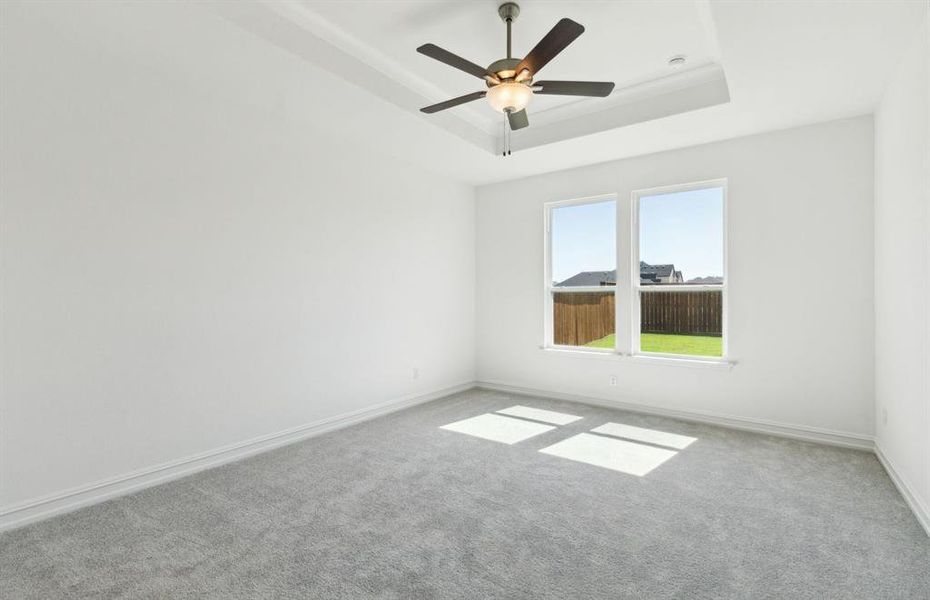 Spacious owner's suite highlighted by large windows and an exquisite tray ceiling *Real home pictured Spacious owner's suite highlighted by large windows and an exquisite tray ceiling *Real home pictured