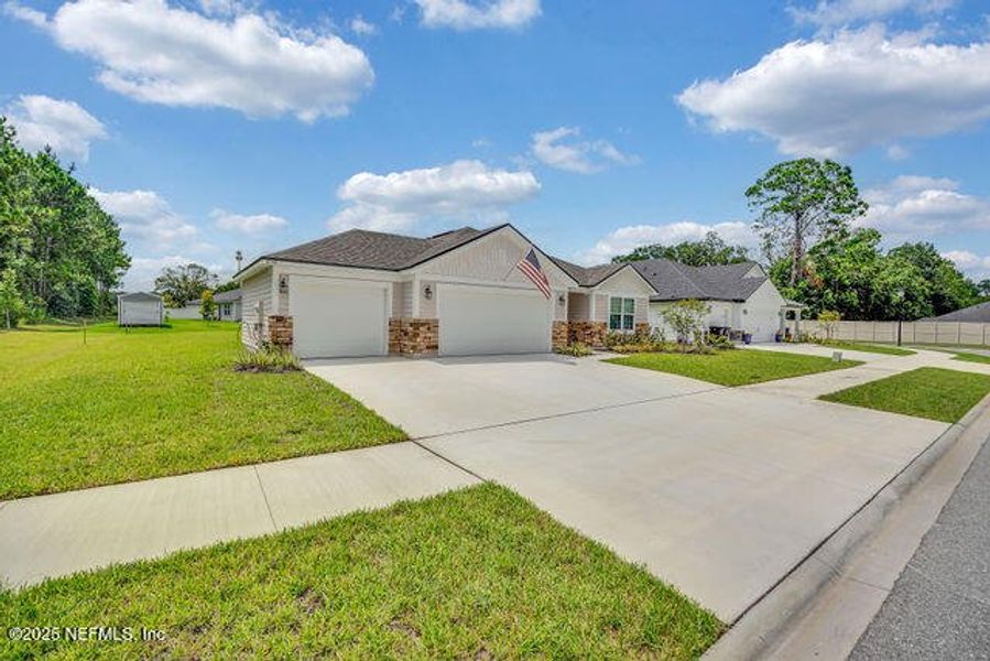 Front exterior of a new home in Edinburgh Village, Jacksonville, FL, highlighting curb appeal (Image 23). Front exterior of a new home in Edinburgh Village, Jacksonville, FL, highlighting curb appeal (Image 23).