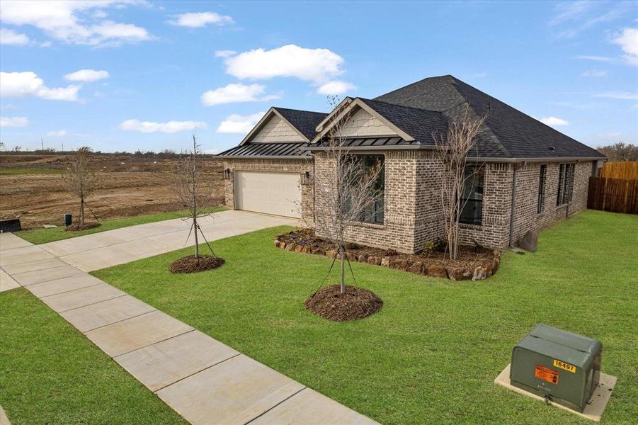 Front exterior of a new home in University Park at Northpointe, Denton, TX, highlighting curb appeal (Image 1).