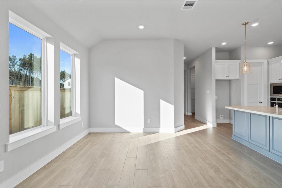 This dining area is a natural extension of the kitchen and living room, allowing for seamless conversation and connection with guests or family members, even when preparing a meal.