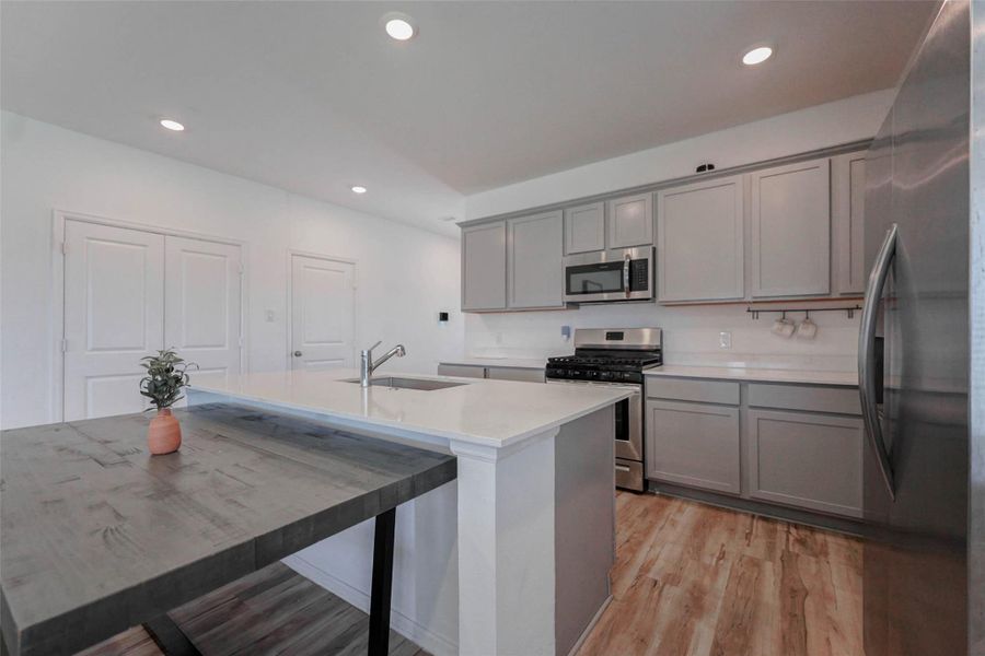 Stylish Katy TX kitchen with shaker cabinets, sleek quartz countertops, and breakfast bar. Entertain with ease in this move-in-ready Sunterra home near Katy ISD schools. Stylish Katy TX kitchen with shaker cabinets, sleek quartz countertops, and breakfast bar. Entertain with ease in this move-in-ready Sunterra home near Katy ISD schools.