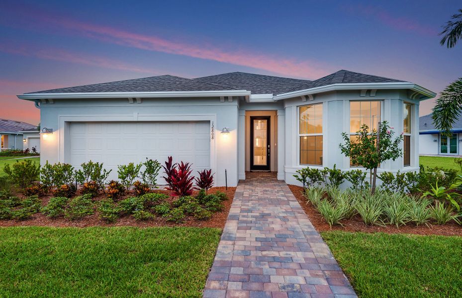 Front exterior of a new home in Del Webb Tradition, Port St. Lucie, FL, highlighting curb appeal (Image 1).