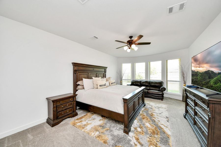 Spacious primary bedroom with abundant natural light.