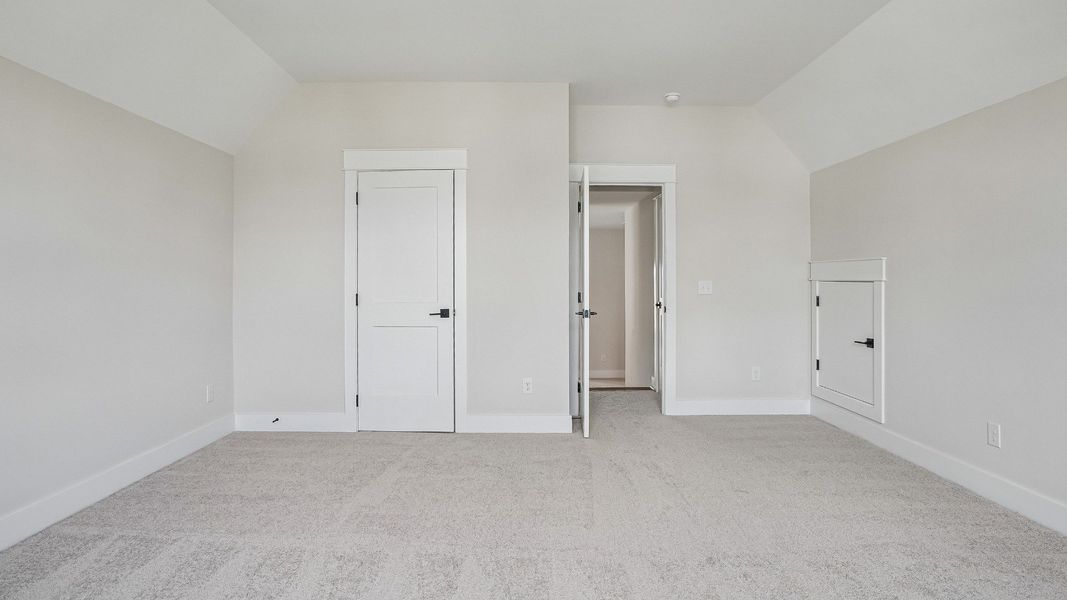 Guest bedroom with vaulted ceiling