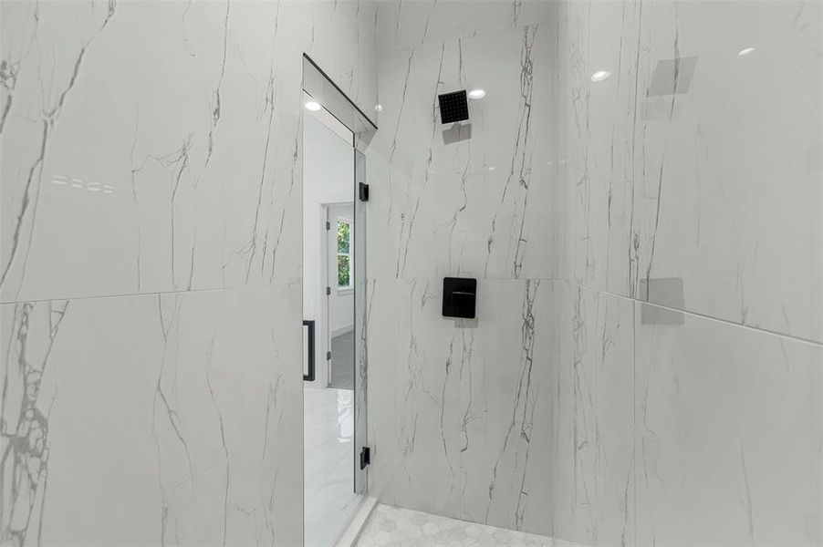 Bathroom featuring a marble finish shower
