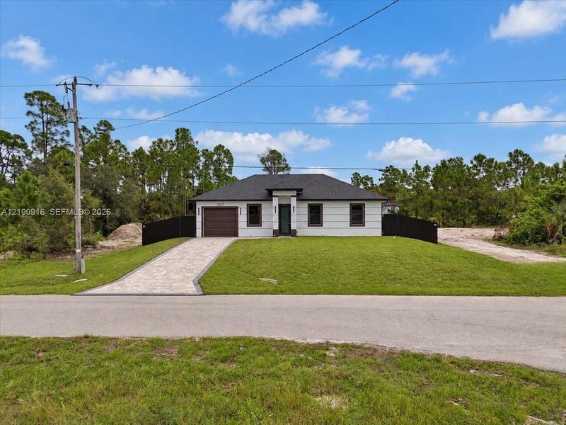 Front exterior of a new home in , Lehigh Acres, FL, highlighting curb appeal (Image 27).