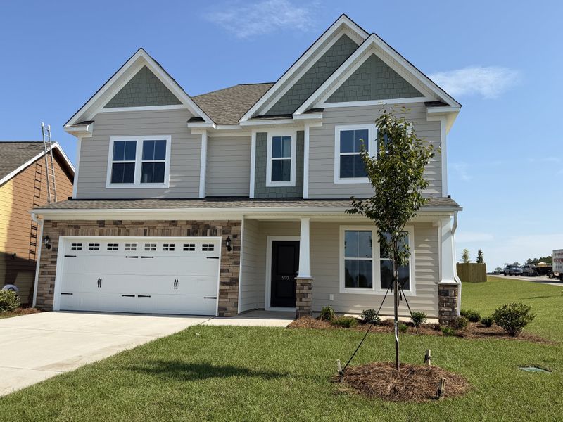 Front exterior of a new home in Gates at Windermere, Blythewood, SC, highlighting curb appeal (Image 1). Front exterior of a new home in Gates at Windermere, Blythewood, SC, highlighting curb appeal (Image 1).