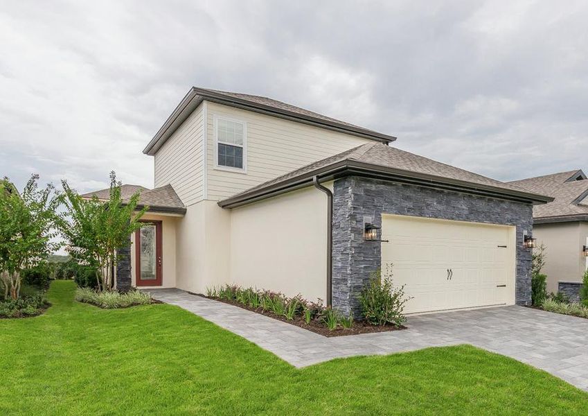 Gorgeous two-story home with stone and siding exterior, a two-car garage and a red front door.