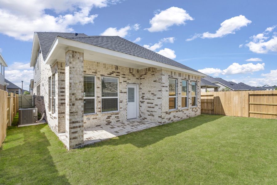 Exterior details and patio area of a home in The Woodlands Hills, Willis (Image 3).