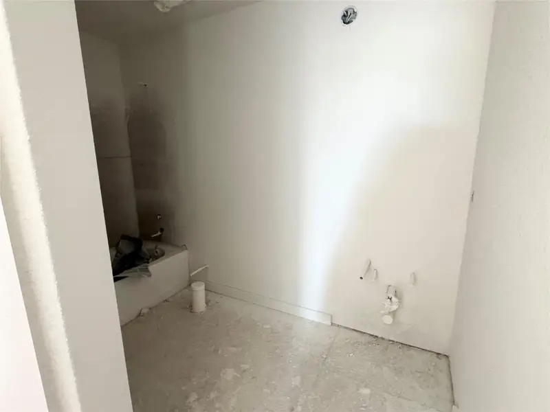 Full bathroom featuring baseboards Full bathroom featuring baseboards