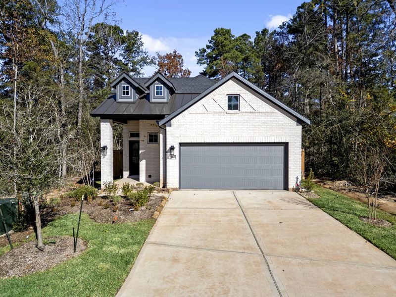 Front exterior of a new home in The Woodlands Hills, Willis, TX, highlighting curb appeal (Image 27). Front exterior of a new home in The Woodlands Hills, Willis, TX, highlighting curb appeal (Image 27).