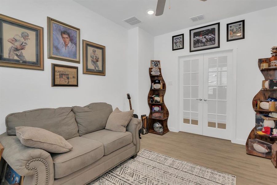 Living room featuring french doors, wood finished floors, and a ceiling fan