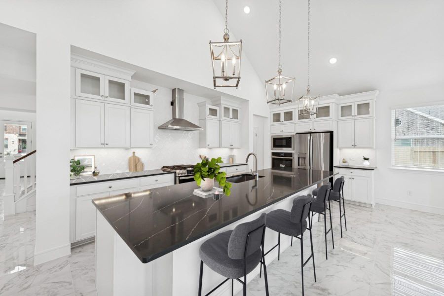 Stunning kitchen with white stacked cabinets and quartz counters