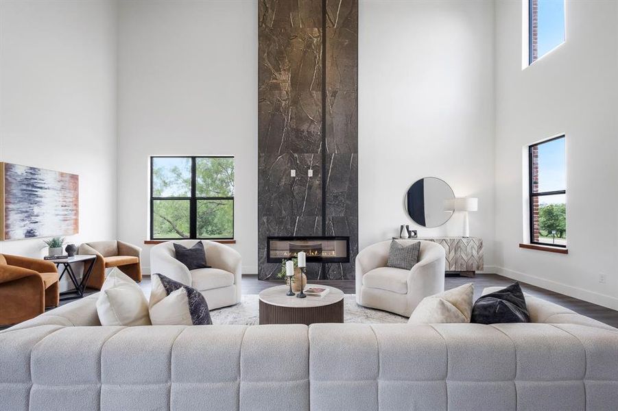 Two-story living area featuring a full-height stone fireplace with a modern linear insert Two-story living area featuring a full-height stone fireplace with a modern linear insert