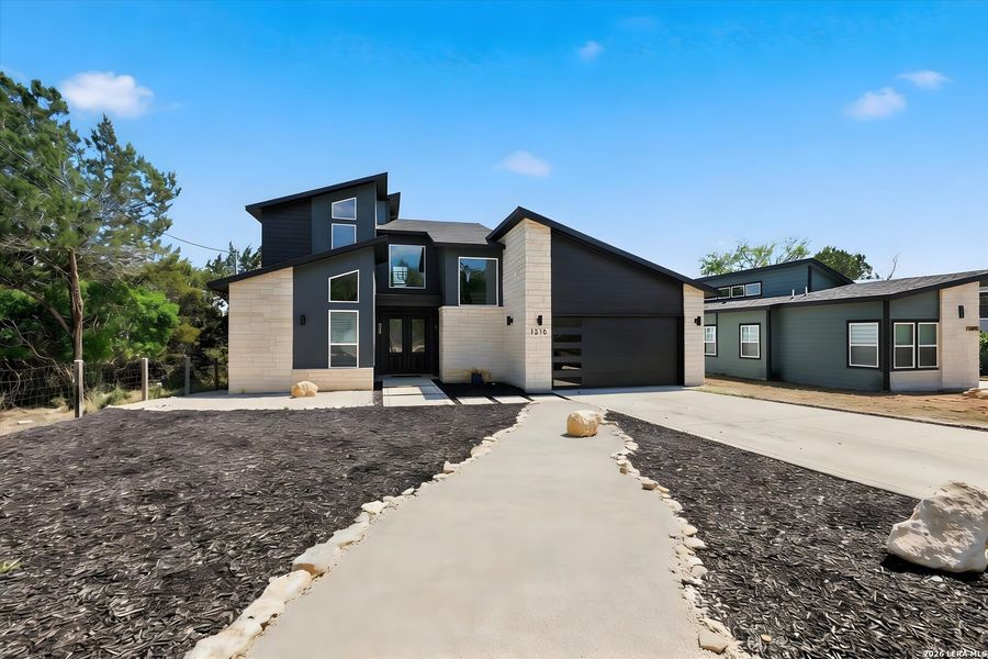 Front exterior of a new home in , Canyon Lake, TX, highlighting curb appeal (Image 25).