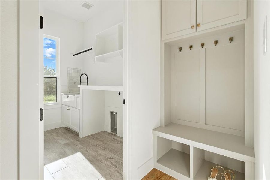 Mudroom with light wood-type flooring