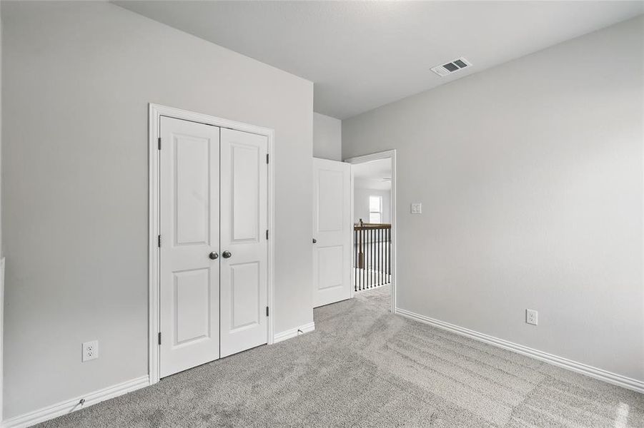 Unfurnished bedroom featuring carpet flooring and a closet