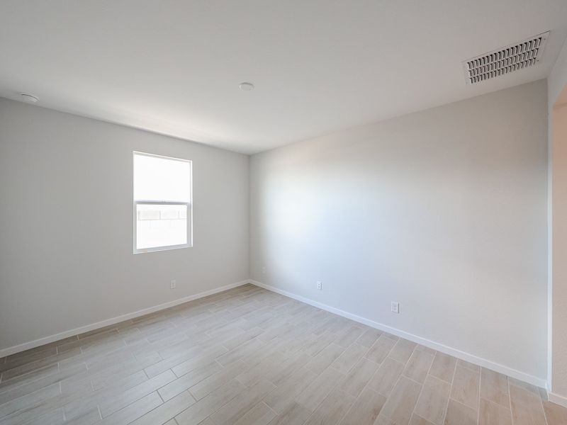 A room with a wood floor and windows.