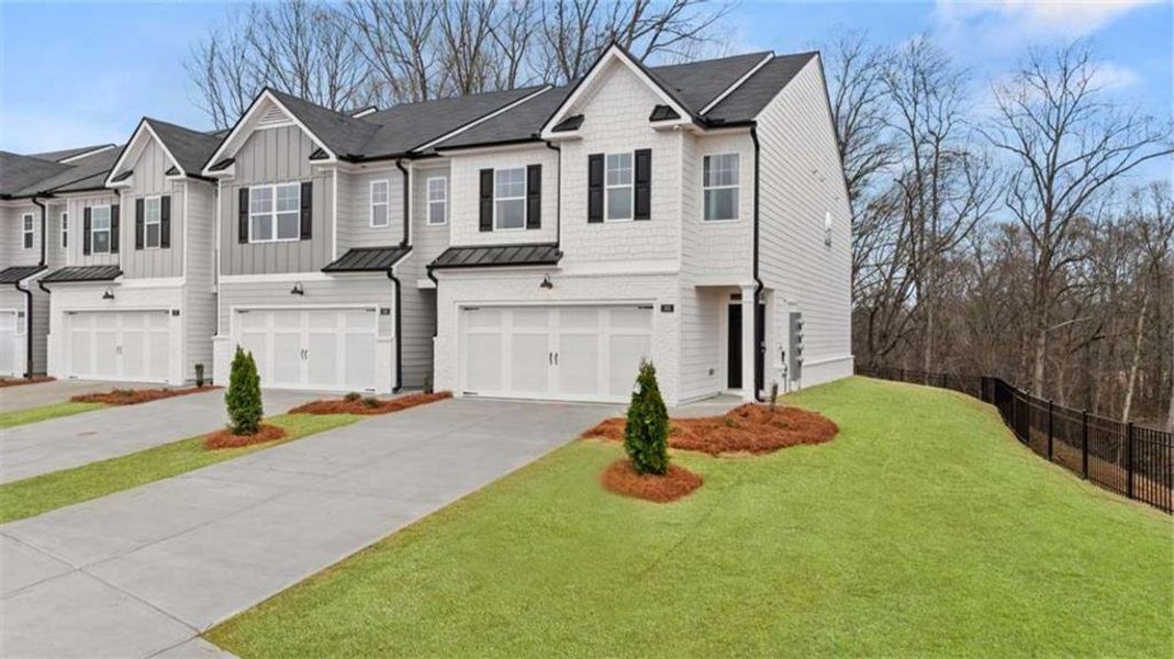 Front exterior of a new home in Echo Glen, Stockbridge, GA, highlighting curb appeal (Image 28). Front exterior of a new home in Echo Glen, Stockbridge, GA, highlighting curb appeal (Image 28).