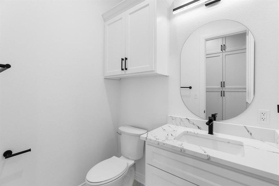 Half bath with vanity and toilet Half bath with vanity and toilet