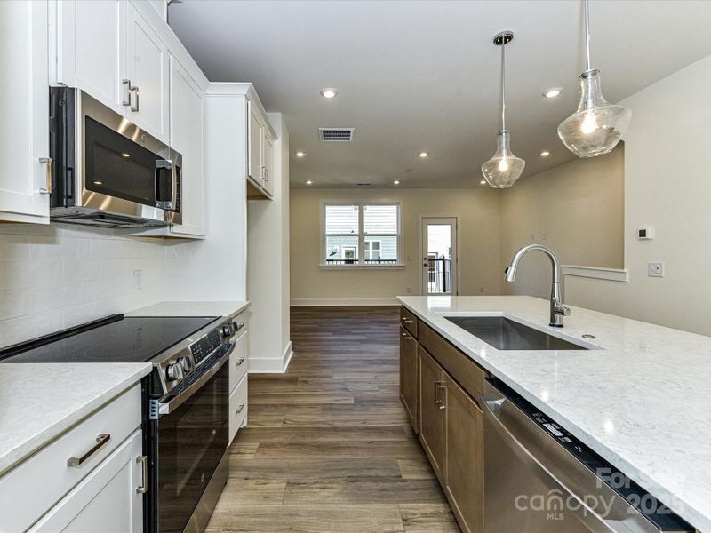 Quartz Countertops and GE Stainless Appliances Complete the Space.