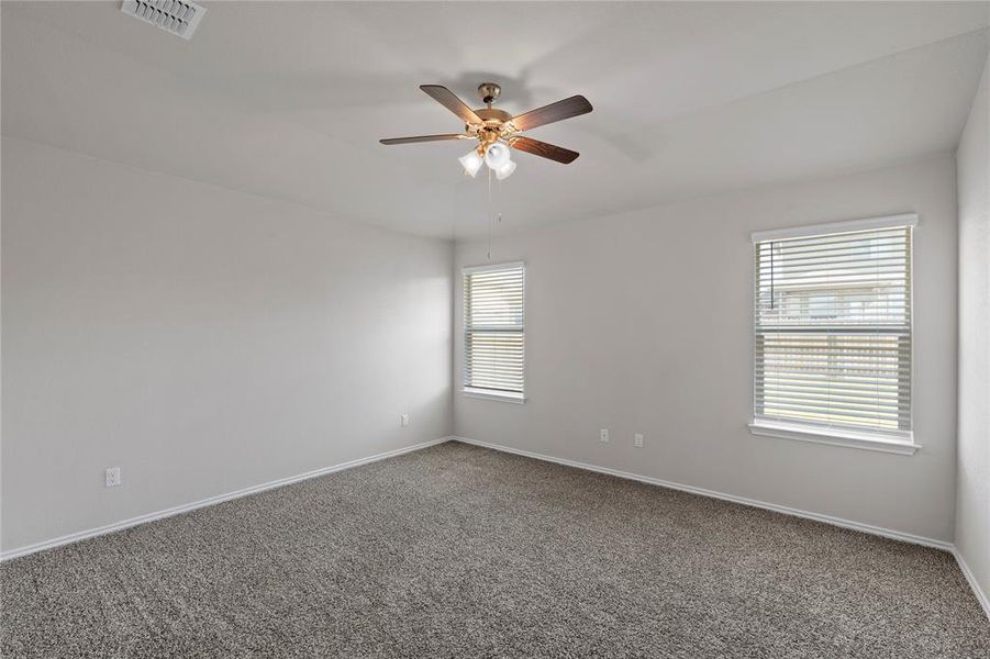 Unfurnished room featuring carpet and a ceiling fan Unfurnished room featuring carpet and a ceiling fan