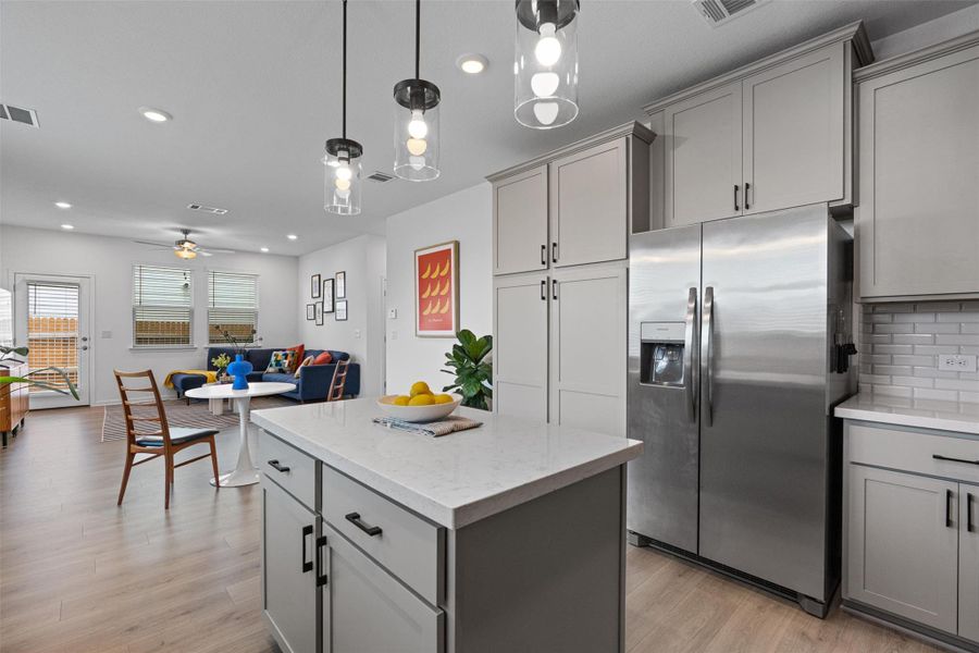 Kitchen featuring stainless steel appliances, gray cabinets, center island, and recessed lighting