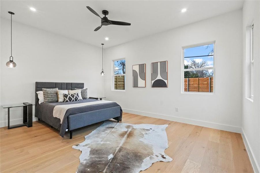 Bedroom with light wood-type flooring, a ceiling fan, and recessed lighting