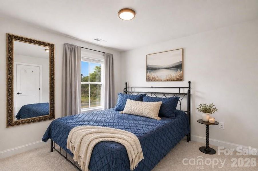 Comfortable secondary bedroom for guests or family.