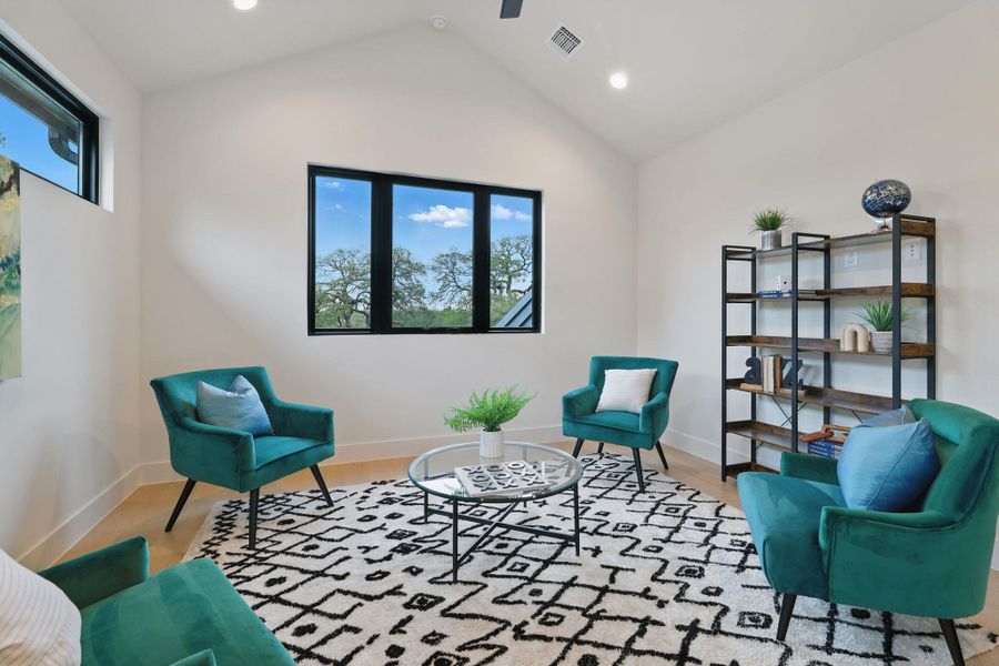Living area featuring wood finished floors, lofted ceiling, recessed lighting, and a ceiling fan