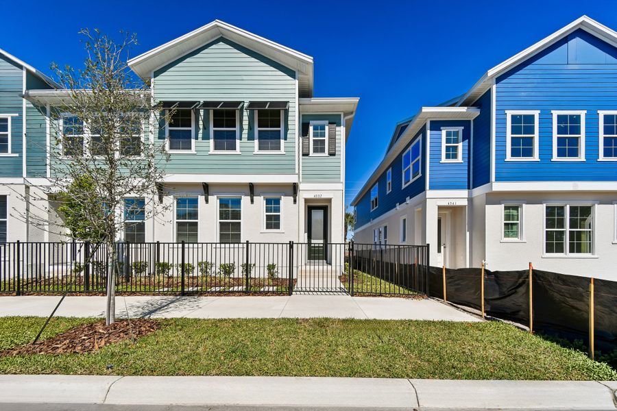 Front exterior of a new home in Baldwin Crossing 22', Orlando, FL, highlighting curb appeal (Image 1). Front exterior of a new home in Baldwin Crossing 22', Orlando, FL, highlighting curb appeal (Image 1).