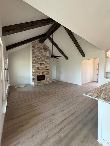 Large living with cathedral ceiling, stained beams and double back patio door