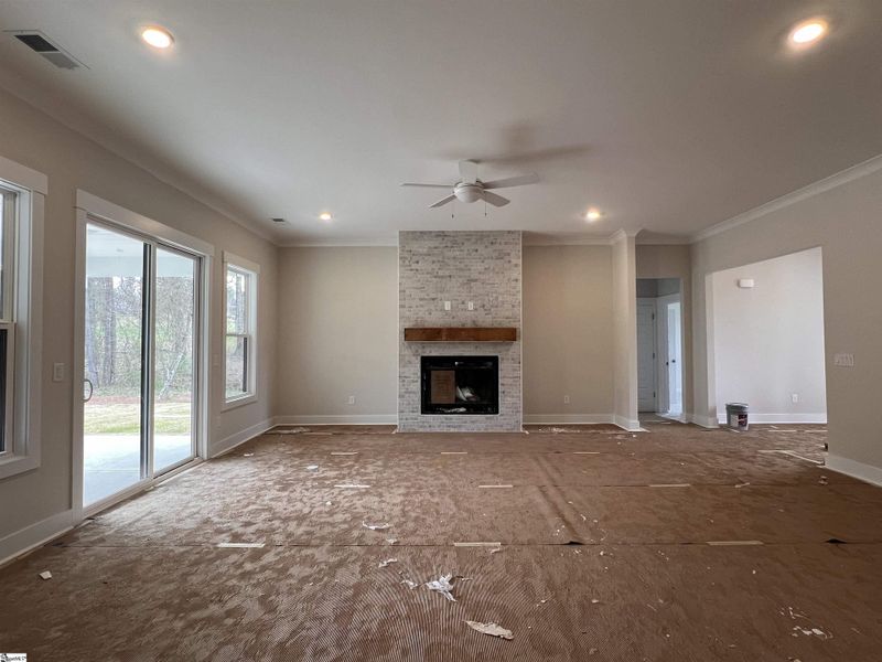 Living room featuring a gas burning fireplace with access to screened porch.