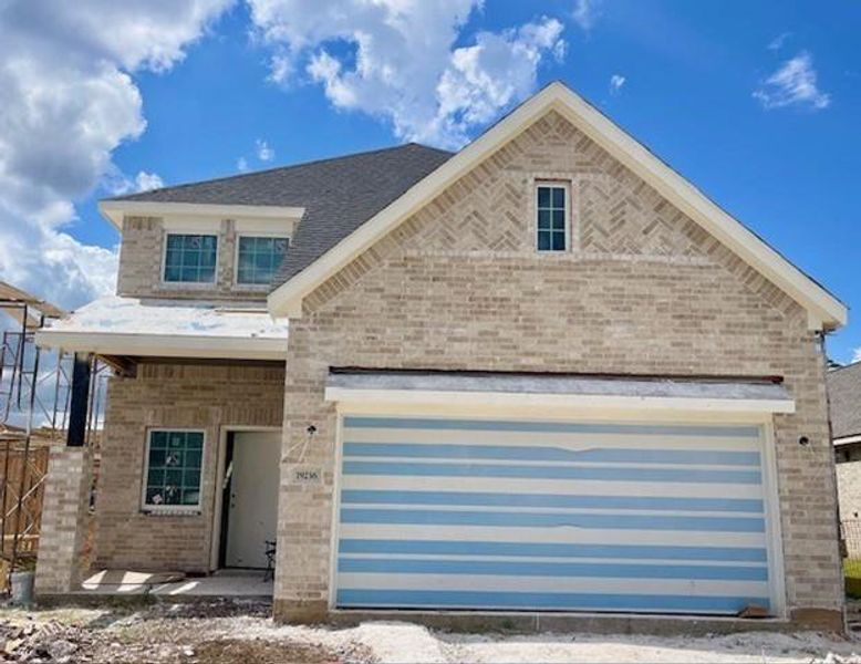 Front exterior of a new home in Emory Glen, Magnolia, TX, highlighting curb appeal (Image 17).
