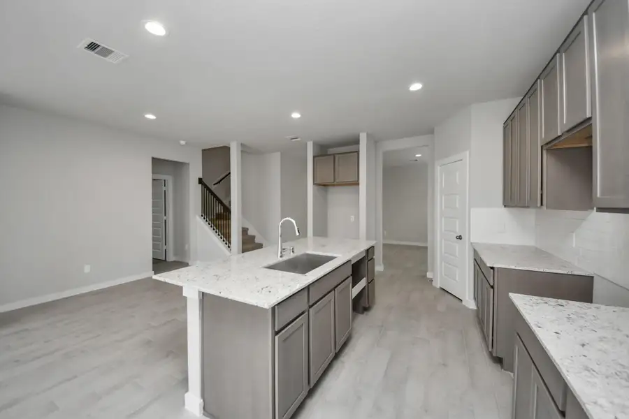 Discover another perspective of this stunning kitchen, generously appointedwith an abundance of counter space. Sample photo of completed home with similar floor plan. Actual colors and selections may vary. Discover another perspective of this stunning kitchen, generously appointedwith an abundance of counter space. Sample photo of completed home with similar floor plan. Actual colors and selections may vary.