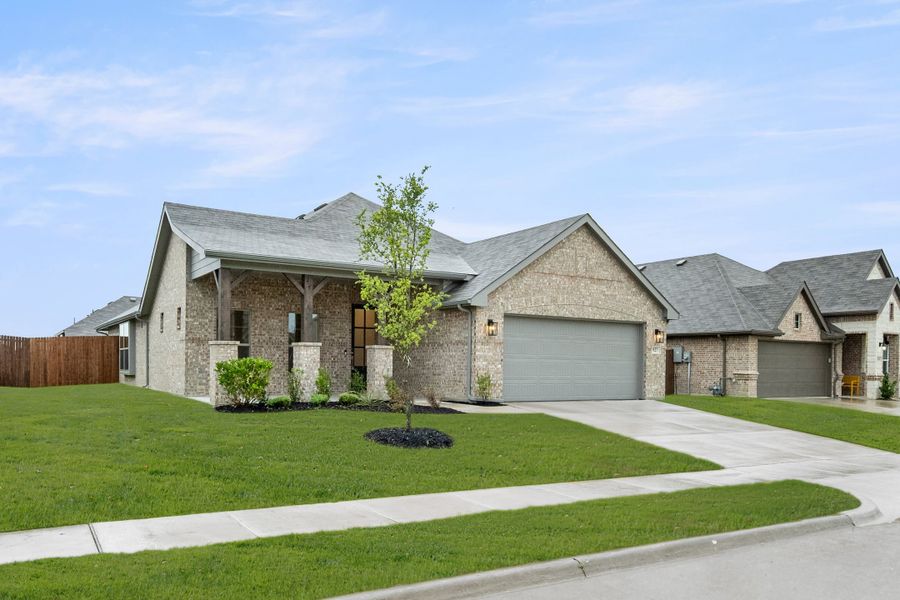 Front exterior of a new home in Chisholm Hills, Cleburne, TX, highlighting curb appeal (Image 2). Front exterior of a new home in Chisholm Hills, Cleburne, TX, highlighting curb appeal (Image 2).