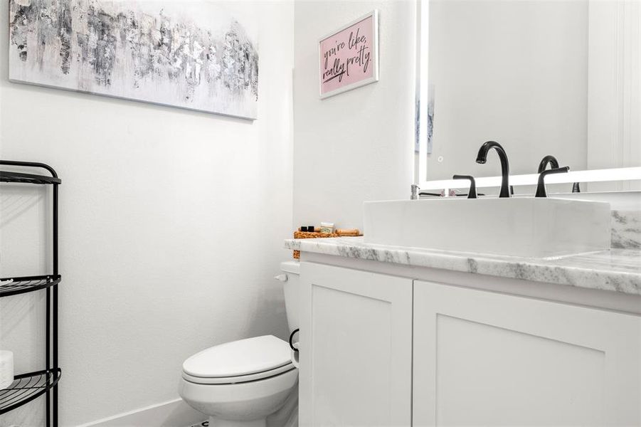 Bathroom featuring vanity and toilet