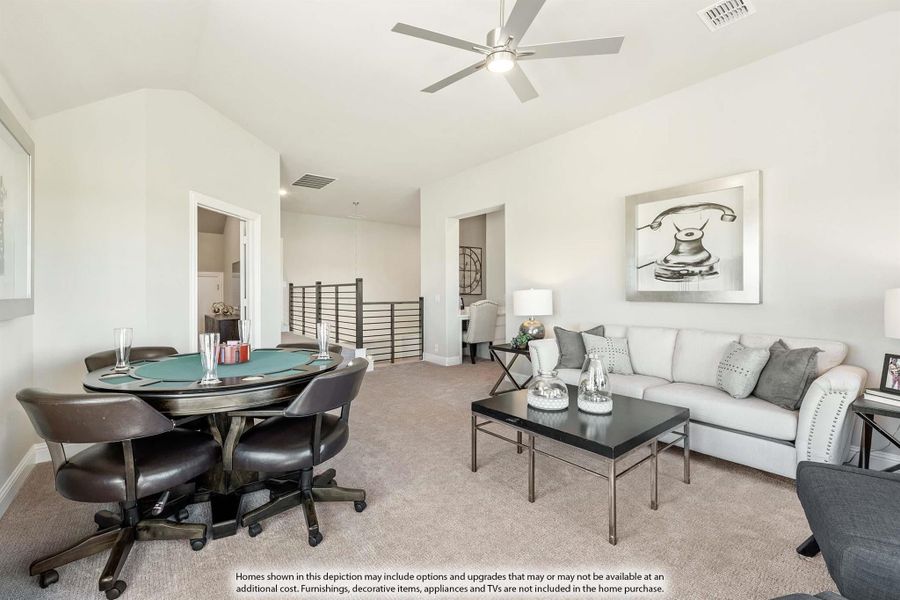 Upstairs game room with poker table, sofa, ceiling fan, and open staircase railing on carpet flooring