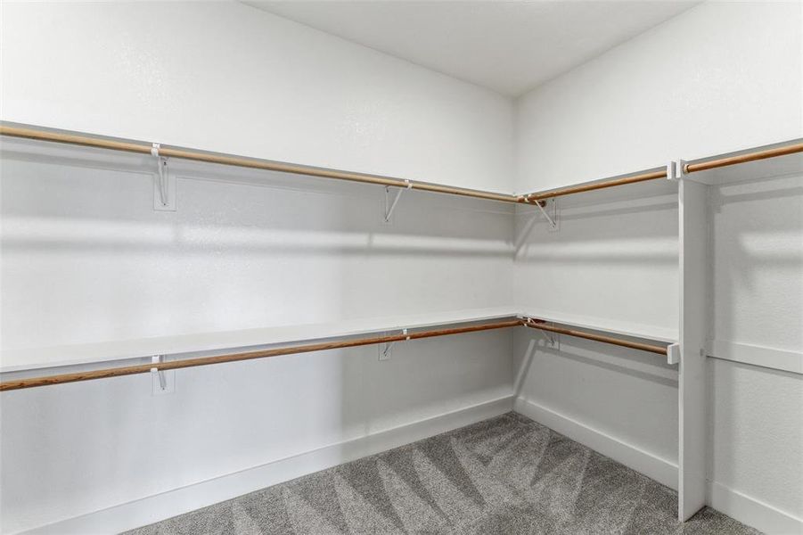 Primary walk-in closet. Primary walk-in closet.
