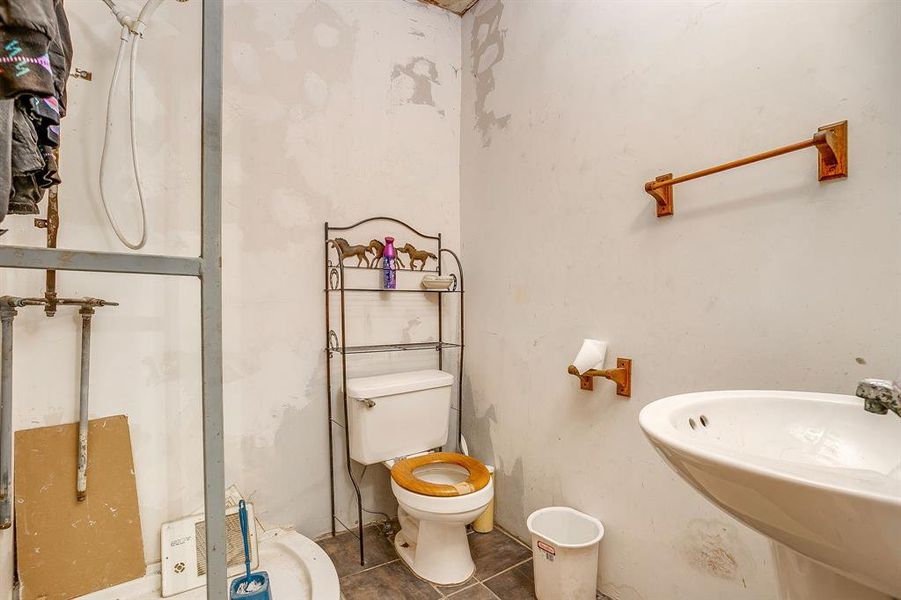 Bathroom featuring toilet and tile patterned floors Bathroom featuring toilet and tile patterned floors