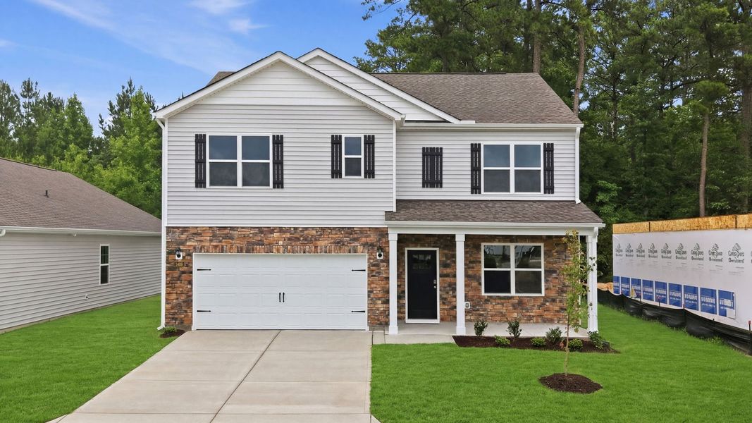 Front exterior of a new home in Ridgewood Farms, Winterville, NC, highlighting curb appeal (Image 2). Front exterior of a new home in Ridgewood Farms, Winterville, NC, highlighting curb appeal (Image 2).
