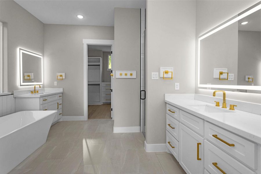 Spa-like en suite with soaking tub, oversized walk-in shower, and double vanities with backlit mirrors. Spa-like en suite with soaking tub, oversized walk-in shower, and double vanities with backlit mirrors.