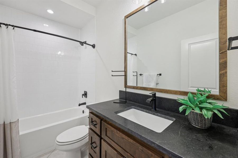 Full bathroom with vanity, shower / tub combo, light tile patterned floors, and recessed lighting Full bathroom with vanity, shower / tub combo, light tile patterned floors, and recessed lighting