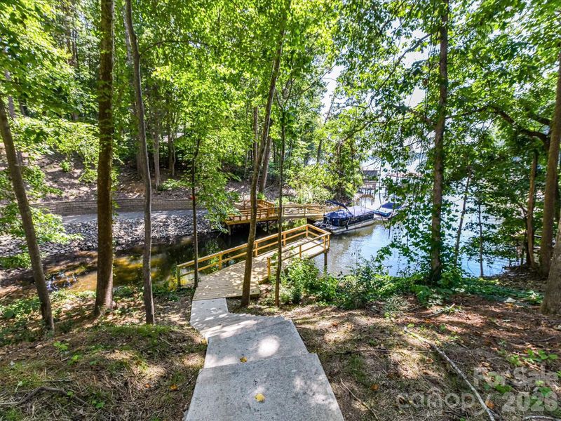 Aerial view highlighting the home’s prime wooded setting and still have the waterfront views of Lake Norman!