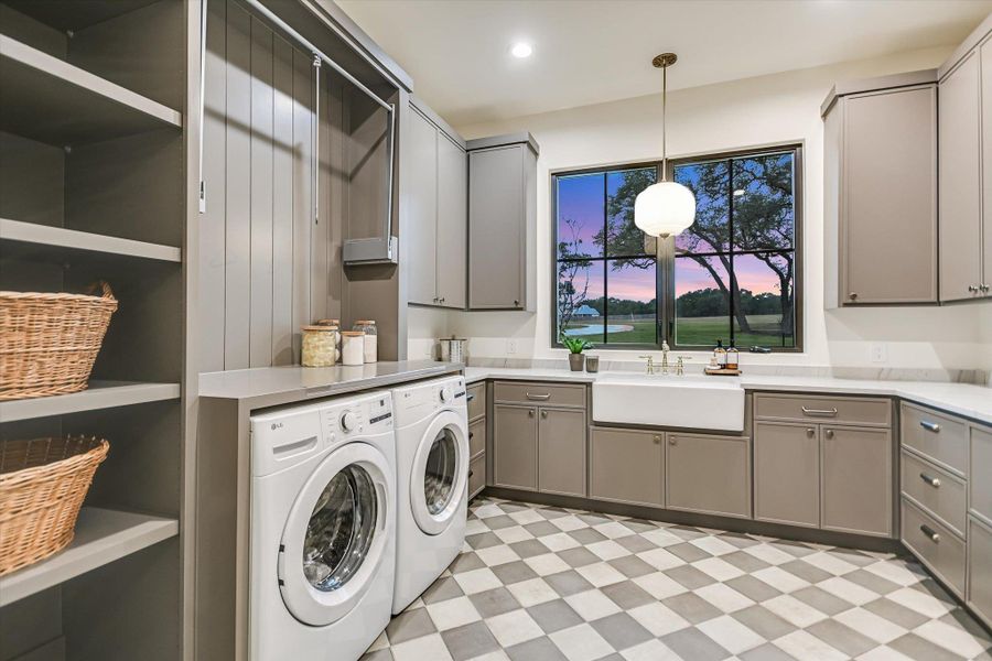 Laundry area with light flooring, separate washer and dryer, cabinet space, and recessed lighting Laundry area with light flooring, separate washer and dryer, cabinet space, and recessed lighting