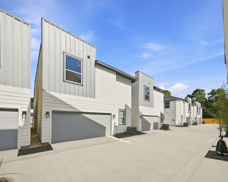 Private internal drive providing convenient access to the rear-entry attached garages, keeping vehicle access within the gated community. Private internal drive providing convenient access to the rear-entry attached garages, keeping vehicle access within the gated community.