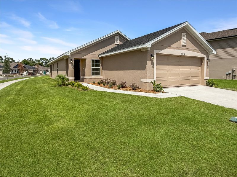 Front exterior of a new home in Harmony Central, St. Cloud, FL, highlighting curb appeal (Image 1). Front exterior of a new home in Harmony Central, St. Cloud, FL, highlighting curb appeal (Image 1).