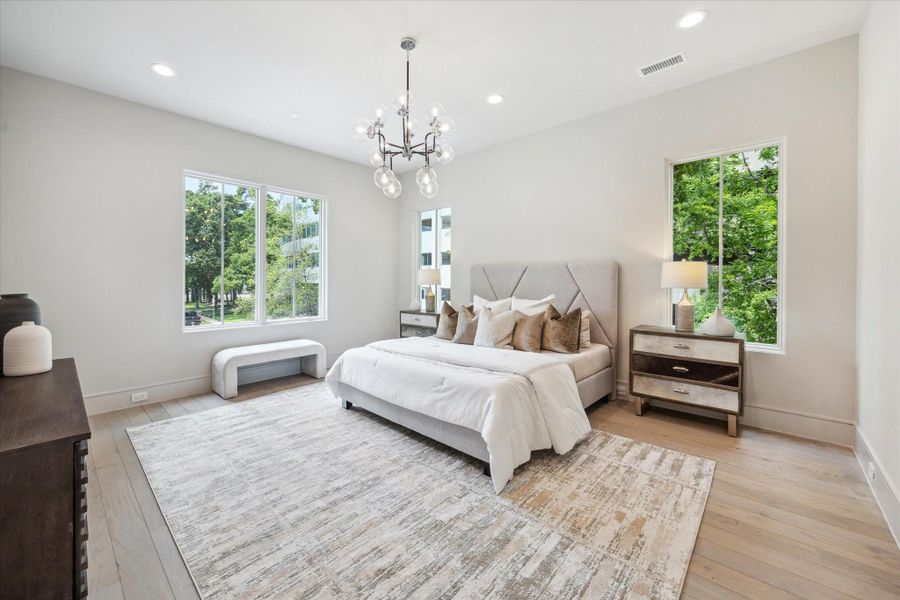 The Primary Suite is adorned with 10-foot ceilings and a designer light fixture. Exquisite Legno Bastone European White Oak wood floors continue in this space adding to its overall elegance and charm. The Primary Suite is adorned with 10-foot ceilings and a designer light fixture. Exquisite Legno Bastone European White Oak wood floors continue in this space adding to its overall elegance and charm.